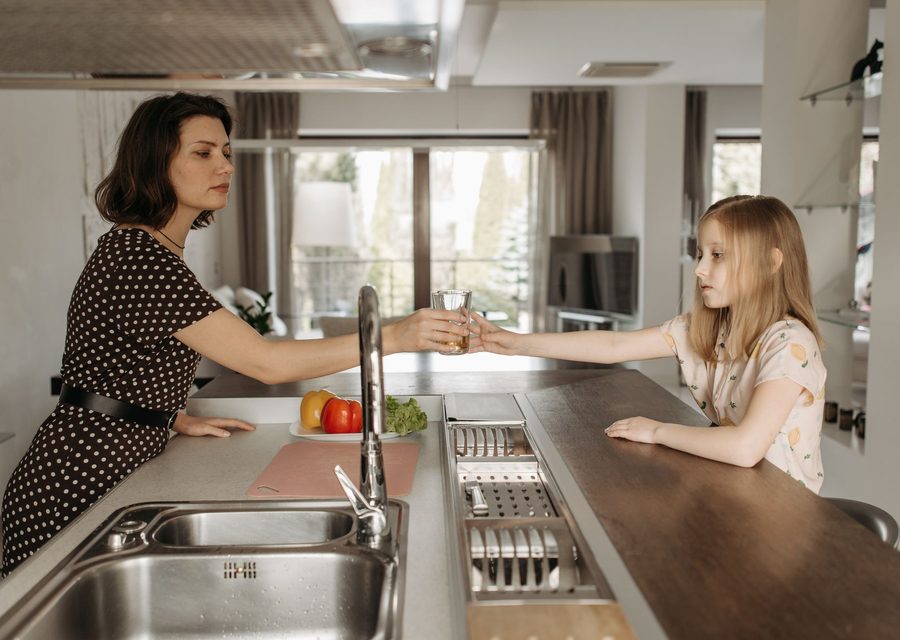 Family enjoying clean water from the kitchen faucet